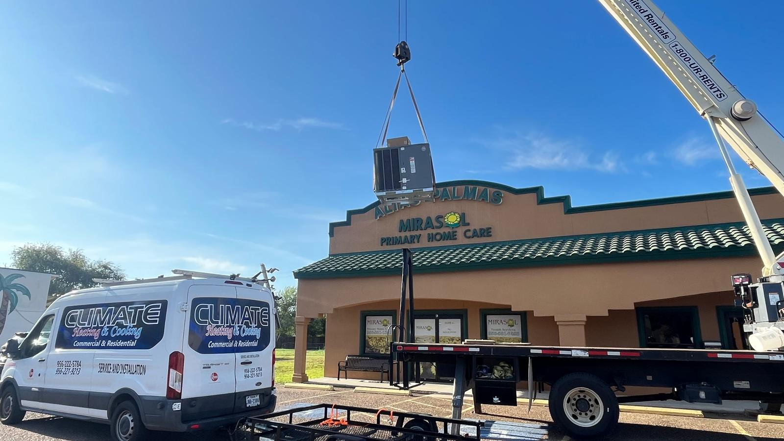 Climate Heating & Cooling crew using a crane to install a new rooftop AC system in the Rio Grande Valley